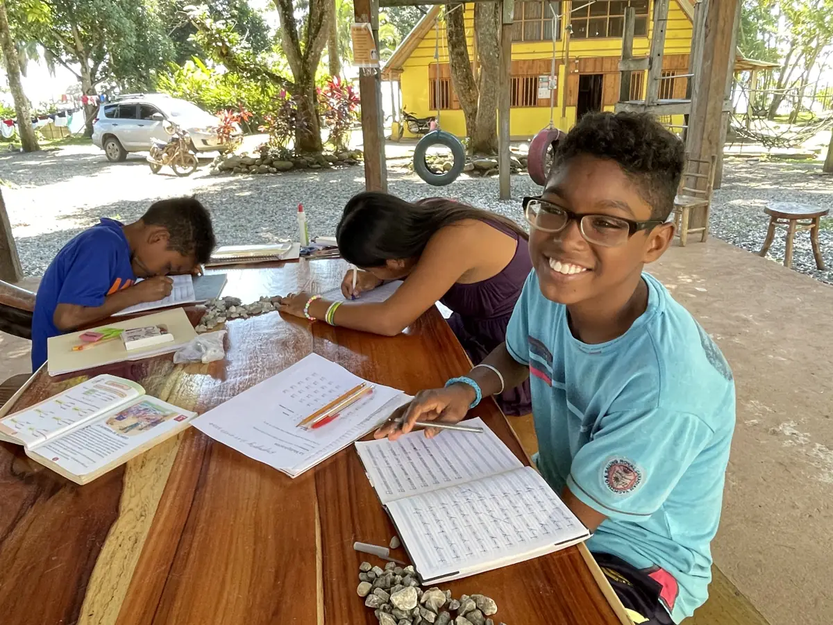 Children studying at the outdoor classroom at Casa Agua Azul in Rio Dulce, Guatemala